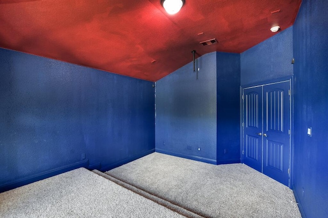 2521 Blended Tree Ranch Dr, Leander, TX 78641 - bonus room featuring carpet, lofted ceiling, and a textured wall