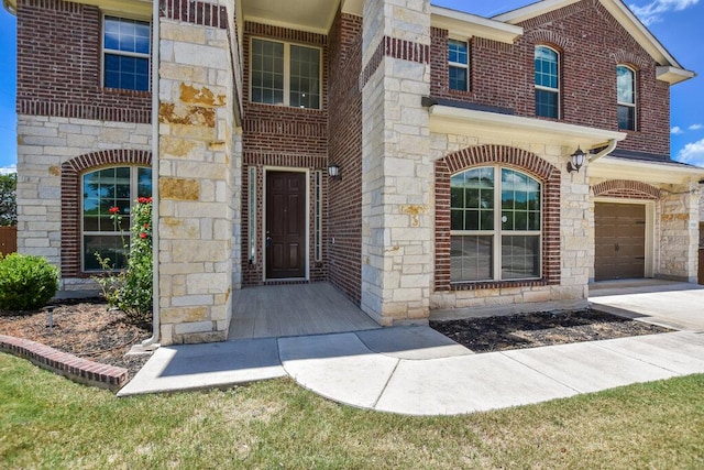 2521 Blended Tree Ranch Dr, Leander, TX 78641 - view of exterior entry with stone siding and a garage