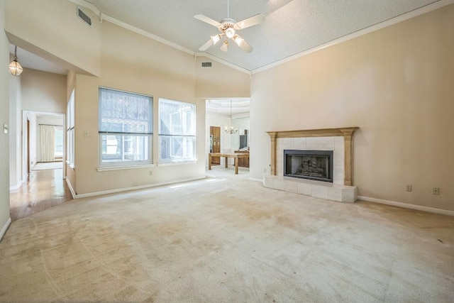 7 Hillway Dr, Round Rock, TX 78664 - unfurnished living room featuring crown molding, carpet, a ceiling fan, a tile fireplace, and high vaulted ceiling