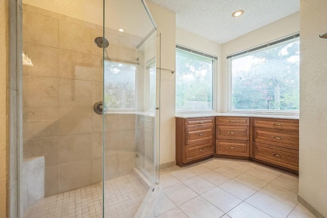 7 Hillway Dr, Round Rock, TX 78664 - full bathroom featuring a stall shower, a textured ceiling, and tile patterned floors