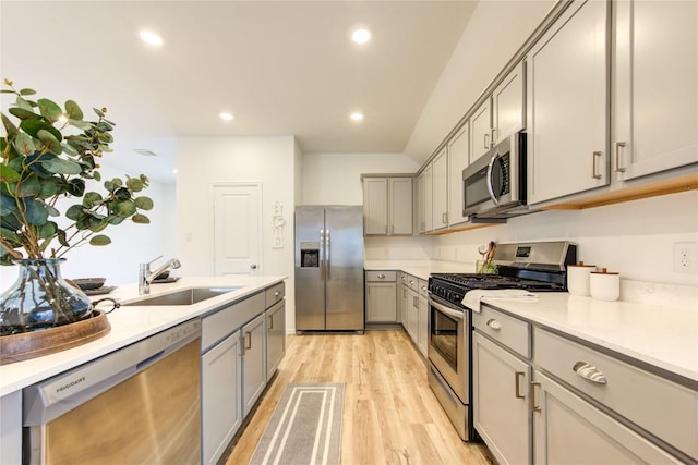 2928 Tantara Dr, Katy, TX 77493 - kitchen with stainless steel appliances, gray cabinets, light wood finished floors, light countertops, and recessed lighting