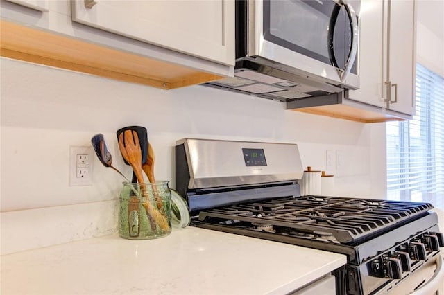 2928 Tantara Dr, Katy, TX 77493 - kitchen view of stainless steel appliances, light countertops, and white cabinets