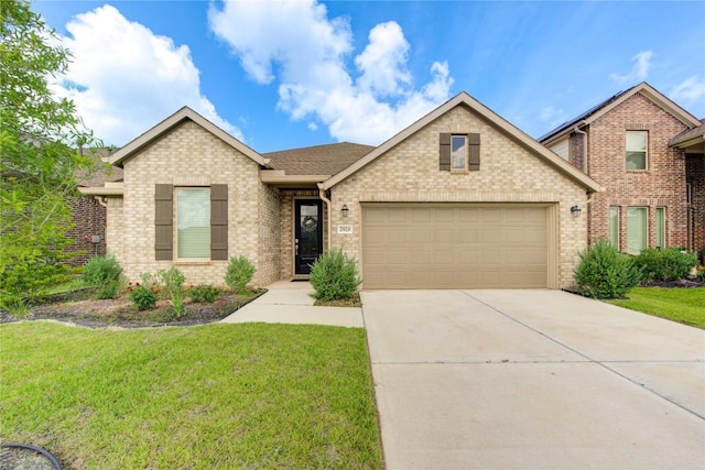2928 Tantara Dr, Katy, TX 77493 - view of front facade featuring an attached garage, concrete driveway, a front lawn, and brick siding