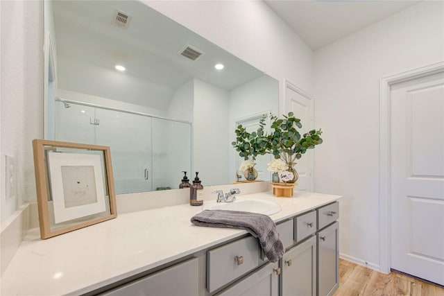 2928 Tantara Dr, Katy, TX 77493 - bathroom with vanity, a shower with door, wood finished floors, and recessed lighting