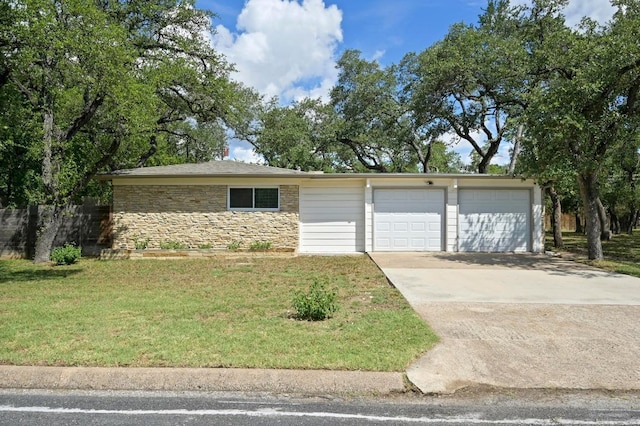 11508 Bell Ave, Austin, TX 78759 - view of front facade featuring a front yard, a garage, concrete driveway, and stone siding