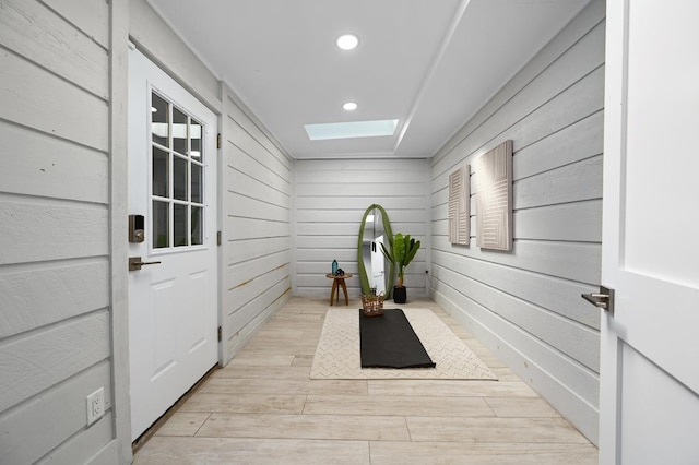 11508 Bell Ave, Austin, TX 78759 - entryway featuring a skylight, recessed lighting, light wood-style flooring, and wood walls
