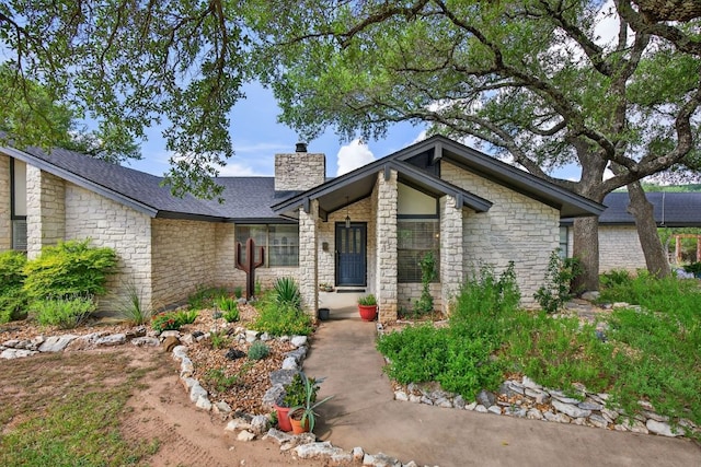 23644 Nameless Rd, Leander, TX 78641 - mid-century home featuring a chimney and stone siding