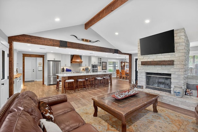 23644 Nameless Rd, Leander, TX 78641 - living room with beamed ceiling, light wood-type flooring, recessed lighting, a fireplace, and high vaulted ceiling