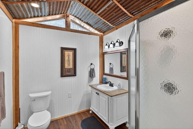 23644 Nameless Rd, Leander, TX 78641 - full bathroom featuring wood finished floors, vanity, vaulted ceiling, and a shower stall
