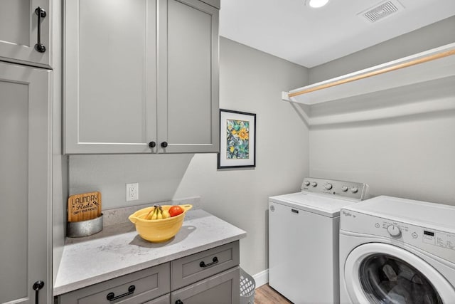 23644 Nameless Rd, Leander, TX 78641 - laundry area with cabinet space and washing machine and dryer