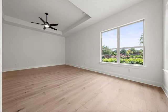 3937 Veneto Cir, Leander, TX 78641 - empty room with a raised ceiling, a ceiling fan, and light wood-style floors