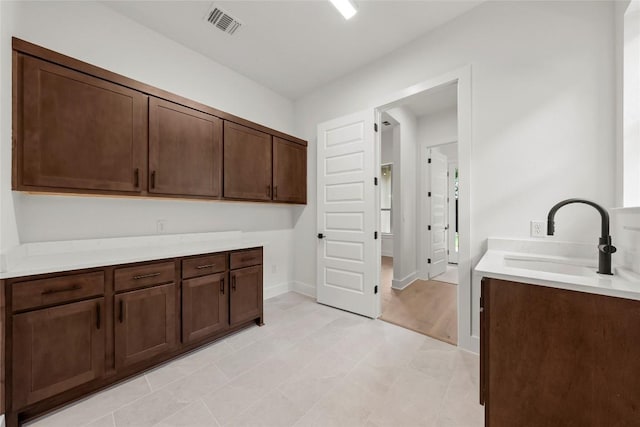 3937 Veneto Cir, Leander, TX 78641 - laundry room with a sink and baseboards