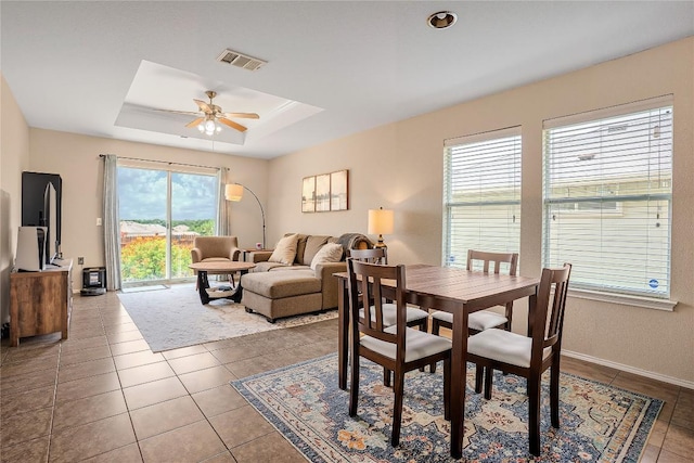8925 China Rose Dr, Austin, TX 78724 - dining area with a ceiling fan, tile patterned floors, and a raised ceiling