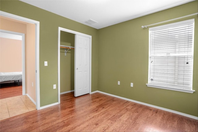 8925 China Rose Dr, Austin, TX 78724 - unfurnished bedroom featuring light wood-style flooring and a closet
