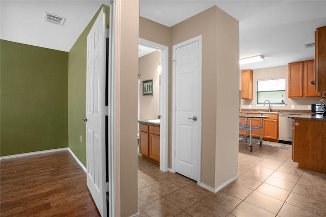 8925 China Rose Dr, Austin, TX 78724 - corridor featuring a sink and light tile patterned floors