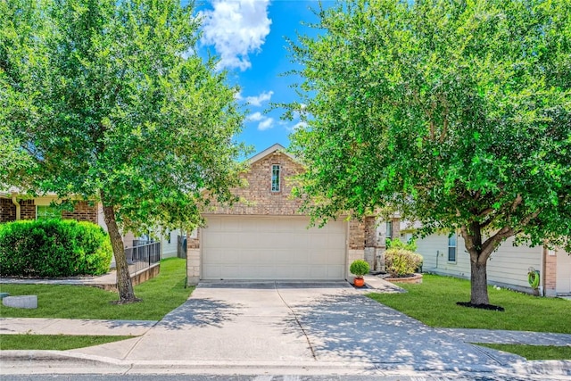 8925 China Rose Dr, Austin, TX 78724 - obstructed view of property with concrete driveway, an attached garage, a front yard, and brick siding