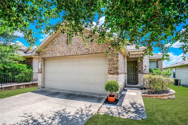8925 China Rose Dr, Austin, TX 78724 - view of front of house with an attached garage, concrete driveway, and stone siding