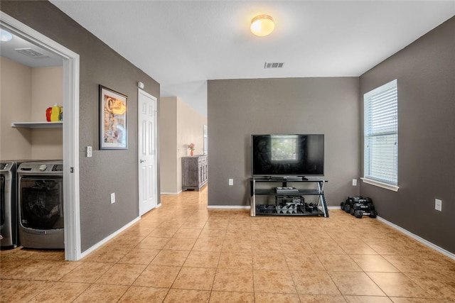 8925 China Rose Dr, Austin, TX 78724 - living room with washer and dryer and light tile patterned flooring