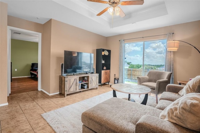 8925 China Rose Dr, Austin, TX 78724 - living room with a tray ceiling, a ceiling fan, and light tile patterned floors