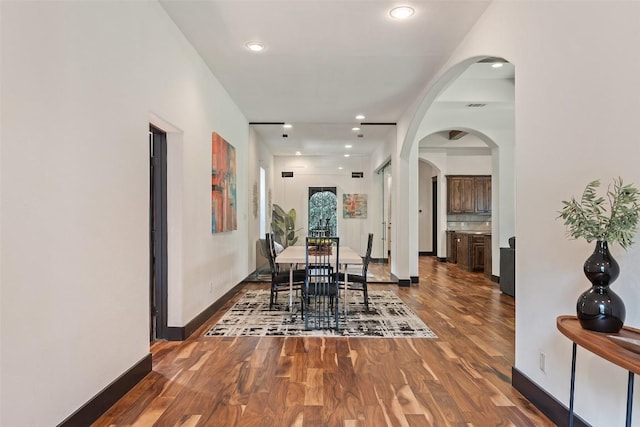 1310 Minnie Dr, Austin, TX 78732 - dining space with wood finished floors, arched walkways, and recessed lighting