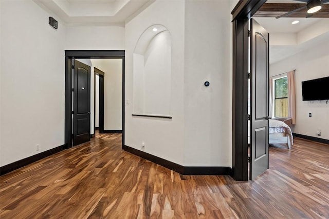 1310 Minnie Dr, Austin, TX 78732 - hallway featuring a raised ceiling, wood finished floors, and recessed lighting