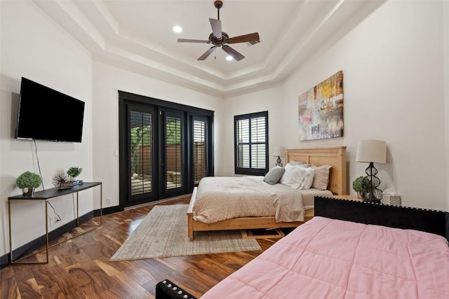 1310 Minnie Dr, Austin, TX 78732 - bedroom with a tray ceiling, access to outside, wood finished floors, ceiling fan, and recessed lighting