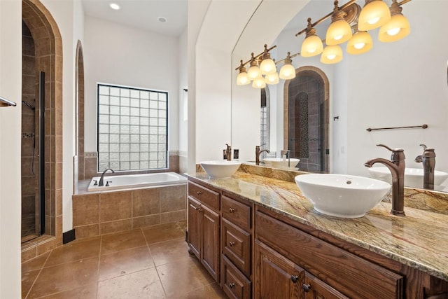 1310 Minnie Dr, Austin, TX 78732 - full bathroom with double vanity, a bath, a stall shower, and tile patterned floors
