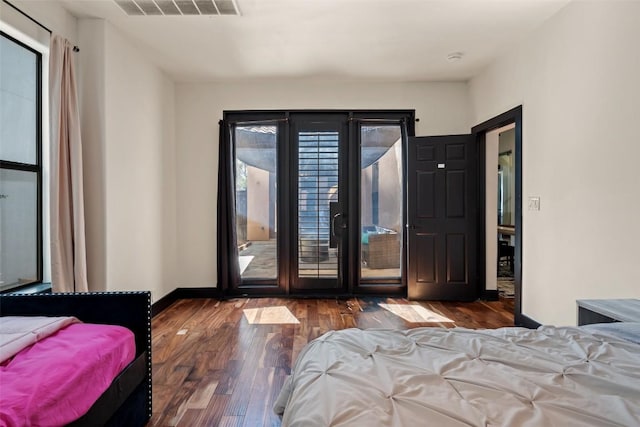 1310 Minnie Dr, Austin, TX 78732 - bedroom with access to outside and wood finished floors