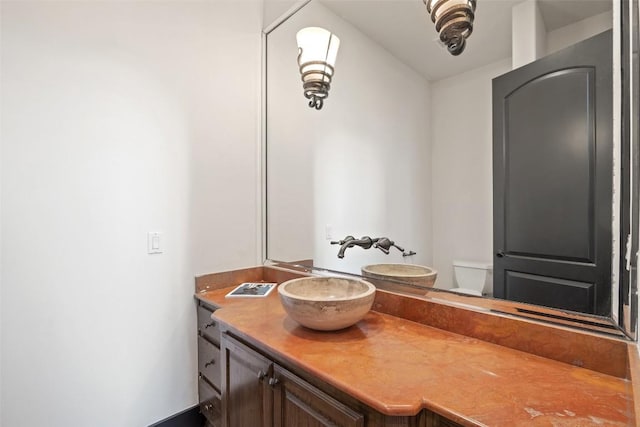 1310 Minnie Dr, Austin, TX 78732 - half bathroom featuring vanity and toilet