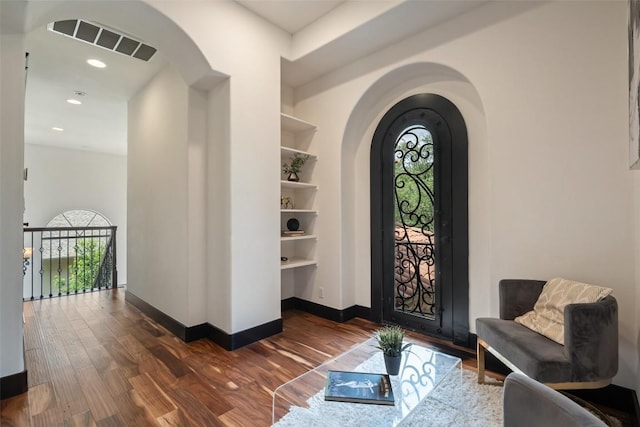 1310 Minnie Dr, Austin, TX 78732 - entrance foyer with plenty of natural light, arched walkways, wood finished floors, and recessed lighting