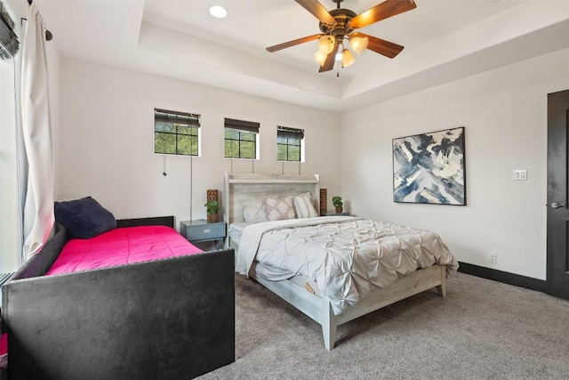 1310 Minnie Dr, Austin, TX 78732 - carpeted bedroom with a tray ceiling, a ceiling fan, and recessed lighting