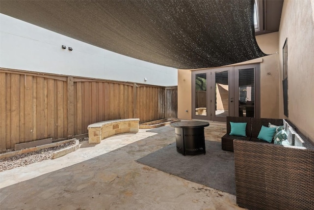 1310 Minnie Dr, Austin, TX 78732 - fenced backyard featuring french doors, a patio area, and an outdoor hangout area