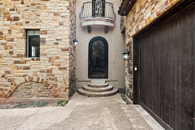 1310 Minnie Dr, Austin, TX 78732 - view of exterior entry with a balcony and stone siding