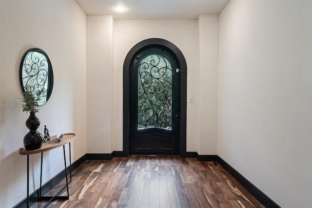 1310 Minnie Dr, Austin, TX 78732 - foyer with wood finished floors and arched walkways