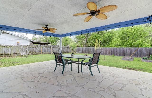 6004 Blythewood Dr, Austin, TX 78745 - fenced backyard featuring a patio, a ceiling fan, and outdoor dining space