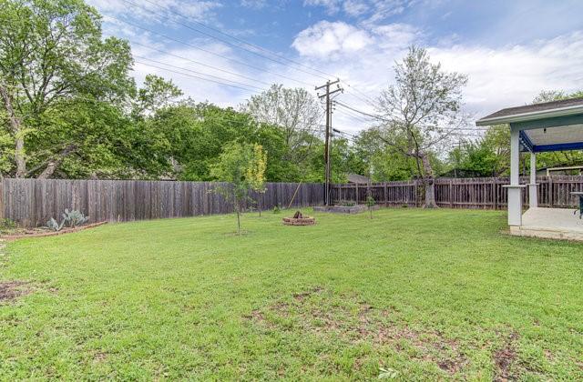 6004 Blythewood Dr, Austin, TX 78745 - fenced backyard featuring an outdoor fire pit
