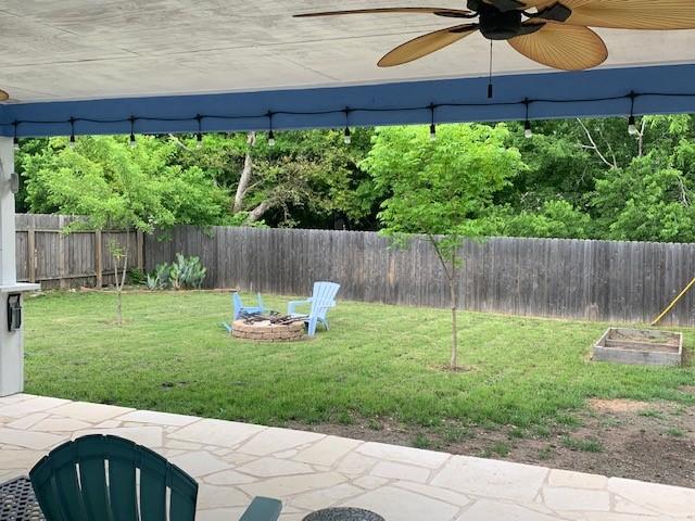 6004 Blythewood Dr, Austin, TX 78745 - fenced backyard featuring ceiling fan and an outdoor fire pit