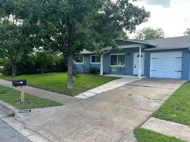 6004 Blythewood Dr, Austin, TX 78745 - ranch-style house with a porch, an attached garage, a front lawn, and driveway