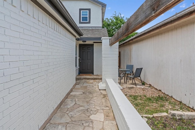 837 Mica Ln, Leander, TX 78641 - doorway to property with a patio and a shingled roof