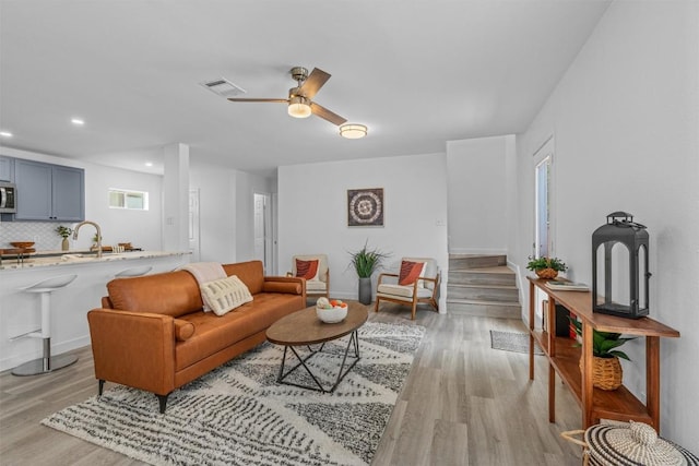 837 Mica Ln, Leander, TX 78641 - living area featuring light wood-style flooring, a ceiling fan, recessed lighting, and stairs