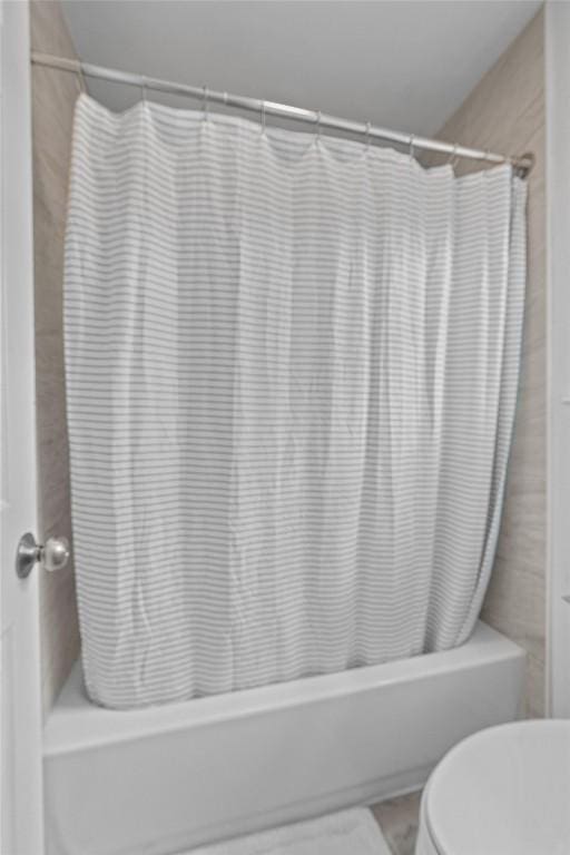 837 Mica Ln, Leander, TX 78641 - bathroom with shower / bath combo with shower curtain and toilet