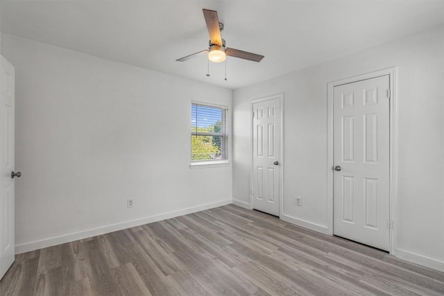 837 Mica Ln, Leander, TX 78641 - unfurnished bedroom with wood finished floors and a ceiling fan
