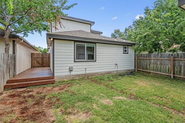 837 Mica Ln, Leander, TX 78641 - rear view of house featuring a fenced backyard, a deck, and roof with shingles