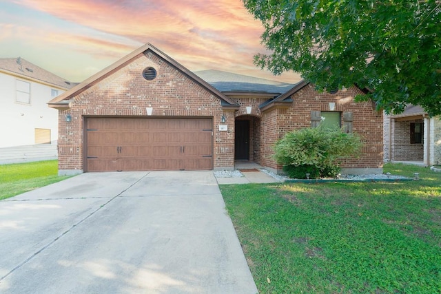913 Mahomet Dr, Pflugerville, TX 78660 - view of front facade with brick siding, a garage, a front yard, and driveway