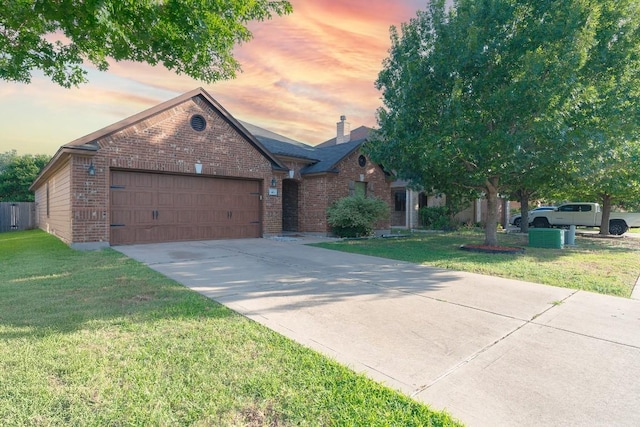 913 Mahomet Dr, Pflugerville, TX 78660 - view of front of house featuring brick siding, a garage, a front lawn, and driveway