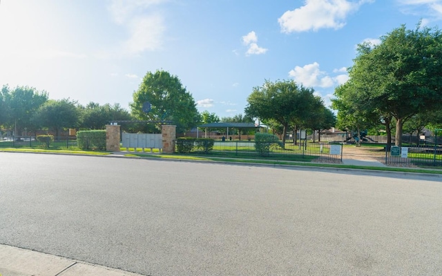 913 Mahomet Dr, Pflugerville, TX 78660 - view of asphalt road with curbs and sidewalks