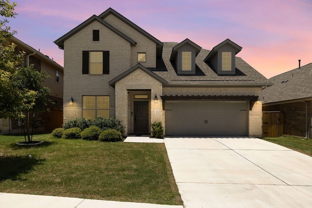 2433 Roaring River Trl, Leander, TX 78641 - view of front of property featuring a lawn, concrete driveway, brick siding, a garage, and a shingled roof