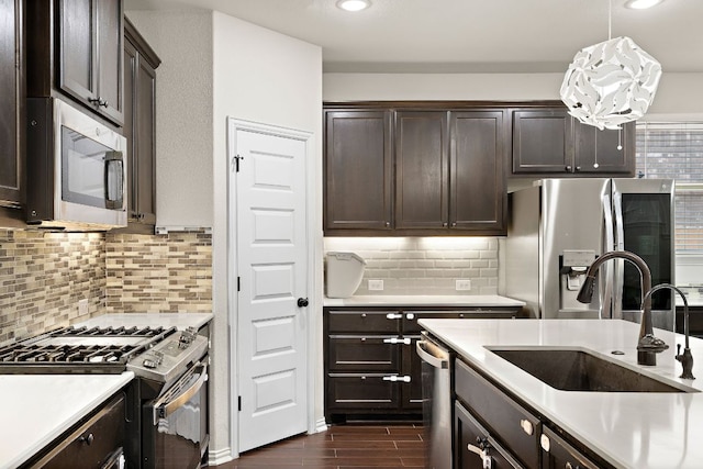 2433 Roaring River Trl, Leander, TX 78641 - kitchen with appliances with stainless steel finishes, dark brown cabinets, light countertops, dark wood-style floors, and recessed lighting
