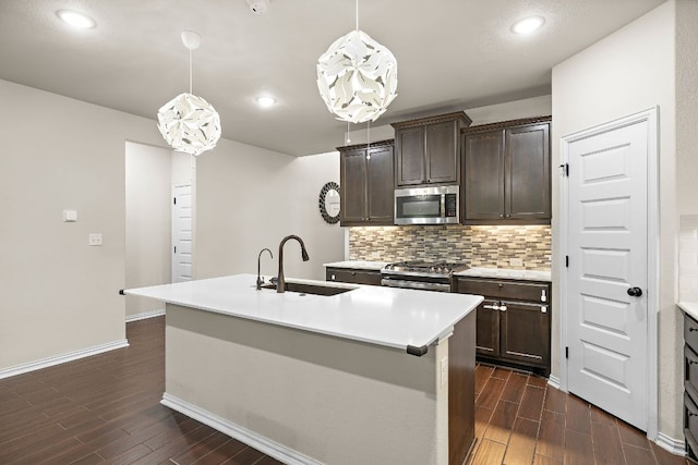 2433 Roaring River Trl, Leander, TX 78641 - kitchen with appliances with stainless steel finishes, dark wood-style flooring, decorative backsplash, dark brown cabinetry, and recessed lighting