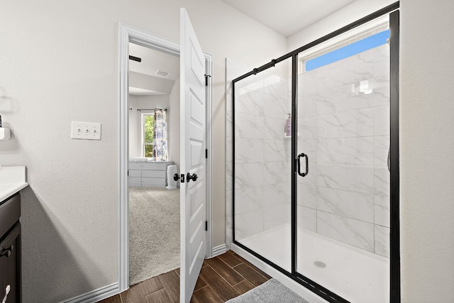 2433 Roaring River Trl, Leander, TX 78641 - bathroom with a shower stall, vanity, and wood finished floors